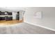 Bright and open living room with carpet and view of the kitchen and staircase at 517 Eagles Way, Mebane, NC 27302