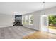 Spacious living room features carpet, a stone fireplace, and a sliding door to the patio at 517 Eagles Way, Mebane, NC 27302
