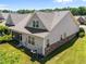 Aerial view of the home's rear exterior, showing the screened porch and surrounding landscaping at 5216 Marcella Ct, Durham, NC 27707
