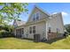 Rear of the house showing siding and stone details, as well as a screened porch at 5216 Marcella Ct, Durham, NC 27707