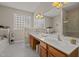 Elegant bathroom with double vanities, a large mirror, and tiled floors at 5216 Marcella Ct, Durham, NC 27707