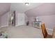 Bedroom with angled ceilings, plush carpet, closet, and a decorative cabinet at 5216 Marcella Ct, Durham, NC 27707