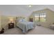 Cozy bedroom with yellow walls, iron bed frame, and natural light from a window at 5216 Marcella Ct, Durham, NC 27707