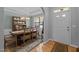 Traditional dining room with wooden table, hutch, chandelier and a floral rug at 5216 Marcella Ct, Durham, NC 27707