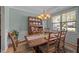 Inviting dining room with classic furniture, decorative hutch, and ample natural light at 5216 Marcella Ct, Durham, NC 27707
