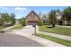 A well-kept stone-front home with a two-car garage, lush lawn, and manicured landscaping at 5216 Marcella Ct, Durham, NC 27707