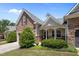 Inviting home with stone accents, lush landscaping, and a covered front porch at 5216 Marcella Ct, Durham, NC 27707