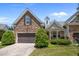Charming home featuring a stone facade, landscaped yard, and a two-car garage at 5216 Marcella Ct, Durham, NC 27707