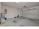 Spacious garage with an automatic door, shelving, and concrete floors at 5216 Marcella Ct, Durham, NC 27707