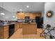 Well-equipped kitchen with wood cabinets, an island, and modern appliances at 5216 Marcella Ct, Durham, NC 27707