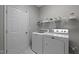 Laundry room with white appliances, shelving, and a bright, clean look at 5216 Marcella Ct, Durham, NC 27707