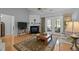 Bright living room features hardwood floors, a fireplace, and a sliding glass door to a patio at 5216 Marcella Ct, Durham, NC 27707