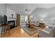 Cozy living room features a fireplace, hardwood floors, and a sliding glass door to a patio at 5216 Marcella Ct, Durham, NC 27707