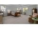 Spacious main bedroom with natural light, tray ceilings, and a cozy sitting area at 5216 Marcella Ct, Durham, NC 27707