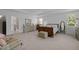 Bright main bedroom featuring ample natural light, tray ceilings, and neutral tones at 5216 Marcella Ct, Durham, NC 27707