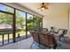 Cozy screened-in patio with comfortable seating, ceiling fan, and views of the backyard at 5216 Marcella Ct, Durham, NC 27707