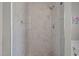 Luxurious walk-in shower featuring marble-look tile, a rain shower head, and glass enclosure at 5216 Marcella Ct, Durham, NC 27707