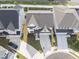 Aerial view of the property featuring driveway, landscaping, and nearby homes in a cul-de-sac at 533 Kings Lake Way, Durham, NC 27703