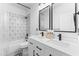 Modern bathroom features a double vanity, geometric tile accents, and sleek black fixtures for a stylish look at 533 Kings Lake Way, Durham, NC 27703