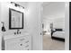 Stylish bathroom features a modern vanity with black hardware, a framed mirror, and shiplap accent wall at 533 Kings Lake Way, Durham, NC 27703