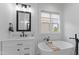 Bright bathroom featuring a vanity with a mirror, and a bathtub with a wooden caddy at 533 Kings Lake Way, Durham, NC 27703