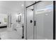 Modern bathroom featuring a walk-in shower with glass door, bathtub, double vanity and marble floors at 533 Kings Lake Way, Durham, NC 27703