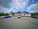 View of the community clubhouse with parking available for residents and guests at 533 Kings Lake Way, Durham, NC 27703