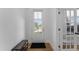 Welcoming entryway featuring a wooden bench, black mat, and a front door with window at 533 Kings Lake Way, Durham, NC 27703