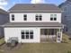 Rear exterior of the home showcasing its white siding, screened-in porch, and well-maintained lawn at 533 Kings Lake Way, Durham, NC 27703
