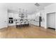 Open concept kitchen featuring an island with seating, stainless appliances, and wood floors at 533 Kings Lake Way, Durham, NC 27703