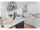 Kitchen with quartz countertops, stainless appliances, an island, and modern light fixtures at 533 Kings Lake Way, Durham, NC 27703
