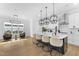 Open kitchen featuring an island, modern lighting, and wood floors at 533 Kings Lake Way, Durham, NC 27703