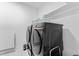 Convenient laundry room features modern appliances, a sleek black washer and dryer set, and a shelf at 533 Kings Lake Way, Durham, NC 27703
