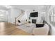 Bright living room with a fireplace, comfortable furniture, and a staircase at 533 Kings Lake Way, Durham, NC 27703