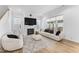 Cozy living room featuring a fireplace, plush furniture, and hardwood floors at 533 Kings Lake Way, Durham, NC 27703