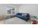 Cozy living room features a comfortable blue sofa and plenty of space for toys and play at 533 Kings Lake Way, Durham, NC 27703
