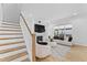 Inviting living room with a fireplace, television, stairway and modern furniture at 533 Kings Lake Way, Durham, NC 27703