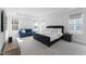 Inviting main bedroom featuring a bed, television, a sitting area and natural light from windows at 533 Kings Lake Way, Durham, NC 27703