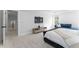 Spacious main bedroom with a sitting area, featuring a tray ceiling and a television with natural light at 533 Kings Lake Way, Durham, NC 27703