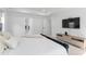 Bright main bedroom featuring a bed, television, tray ceiling and a sitting area with natural light at 533 Kings Lake Way, Durham, NC 27703