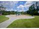Outdoor playground with slides, swings, and climbing structures surrounded by lush green grass at 533 Kings Lake Way, Durham, NC 27703