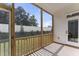 Relaxing screened porch features a wooden railing and peaceful backyard views for outdoor enjoyment at 533 Kings Lake Way, Durham, NC 27703