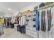 Spacious walk-in closet offers ample storage space with shelves, drawers, and hanging rods for organization at 533 Kings Lake Way, Durham, NC 27703