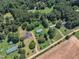 An aerial view of a leafy community, showcasing homes with green lawns and verdant mature tree coverage at 64 Doughty Ln # E, Middlesex, NC 27557