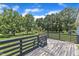 An aging back deck surrounded by mature trees and a lush lawn provides a serene outdoor living space at 64 Doughty Ln # E, Middlesex, NC 27557