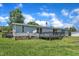 Exterior view of a home with a spacious backyard, accessed by a deck with railing, offering outdoor living at 64 Doughty Ln # E, Middlesex, NC 27557