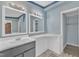 Bathroom featuring a gray sink, countertop, and dual mirrors at 64 Doughty Ln # E, Middlesex, NC 27557