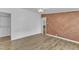 A spacious bedroom features a rustic accent wall and closet at 64 Doughty Ln # E, Middlesex, NC 27557