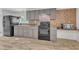 Functional kitchen with black appliances and updated wood-look floors at 64 Doughty Ln # E, Middlesex, NC 27557