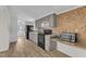 Compact kitchen with black appliances and decorative tile backsplash at 64 Doughty Ln # E, Middlesex, NC 27557